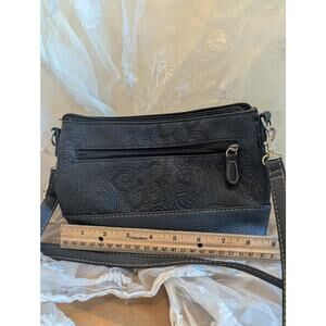 Stone Mountain black paisley leather cross-body bag with gold-toned hardware.